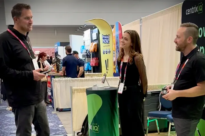 CentrixIQ team chatting with visitors at Expo West with IQ the robot dog